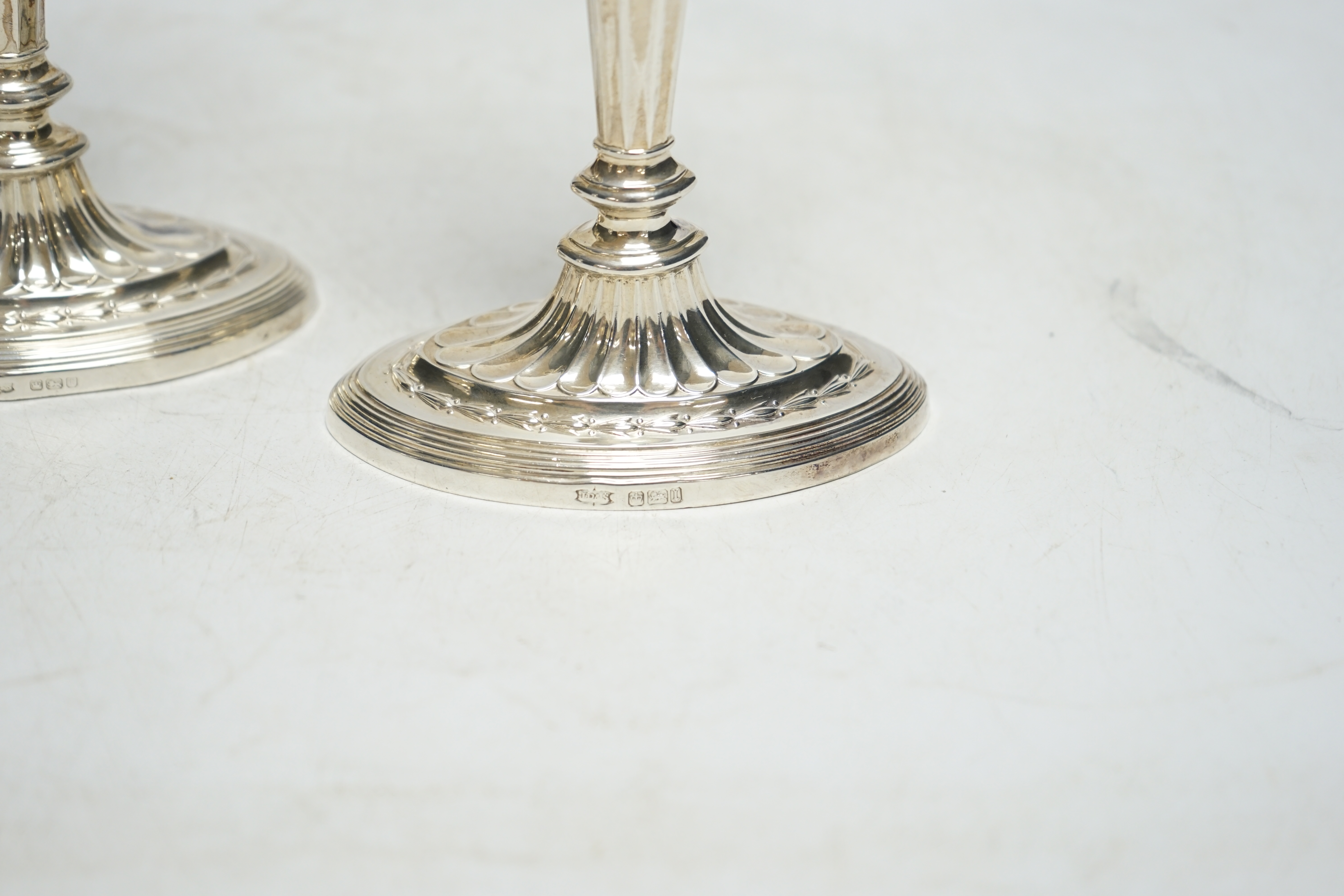 A pair of early 20th century silver oval candlesticks, by James Dixon & Sons, Ltd, Sheffield, 1903 & 1922, 17.2cm, weighted. Condition - fair